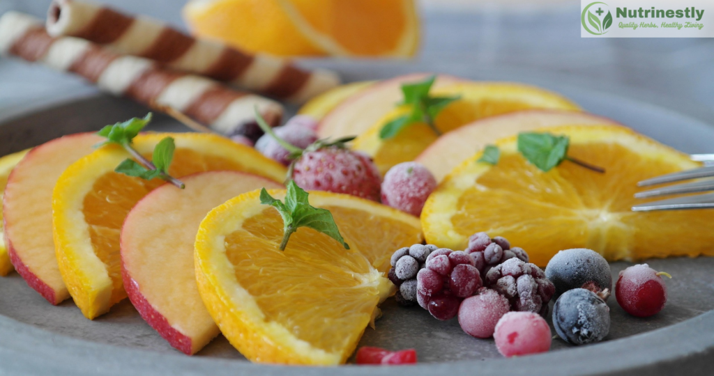 fruit snacks:sliced apples and oranges decorated with berries wafers in a plate