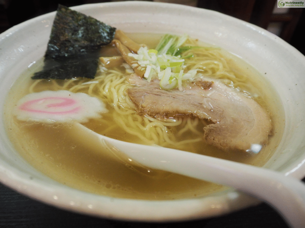 Clear broth low-sodium ramen noodles with sliced pork, seaweed, narutomaki, scallions, and bamboo shoots; a light, heart-friendly ramen dish.
